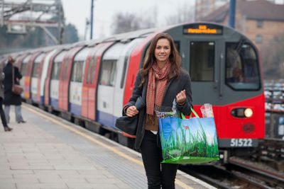 ASDA Click and Collect customer with reusable shopping bag walks away from a train station