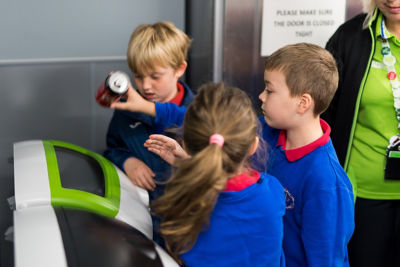 Ruby Edmunds from Aberdare Town Church Primary School and plastic investigators at Asda Aberdare