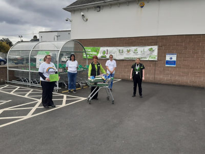 Volunteers from the Friends of Southern Area Hospice collecting a donation for juice cartons from Asda Kilkeel .  | Asda Kilkeel