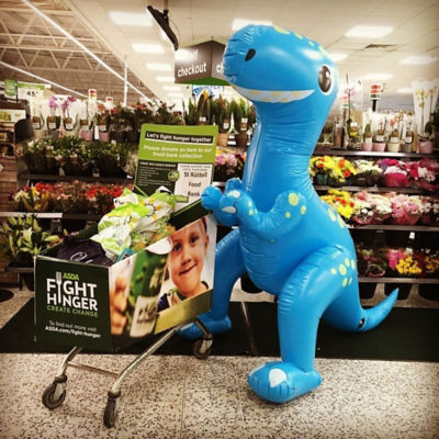 Our full foodbank trolley being guarded by the inflatable dinosaur 🦖 | Asda St Austell