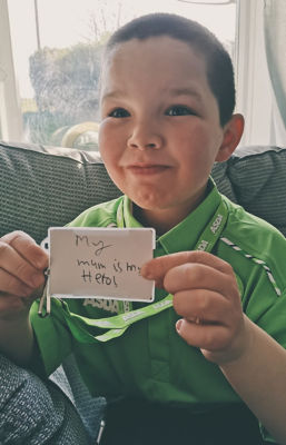 Oliver Neilson dresses in Asda uniform for school superhero day