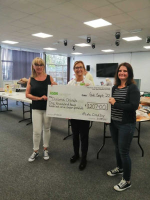 Chroma Church in Leicester receiving their cheque for £1,207 | Asda Oadby
