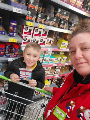 Hayden Santer, whose dad Matt works at Asda Blyth, with his donation to Blyth Food Bank