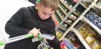 Hayden Santer, whose dad Matt works at Asda Blyth, with his donation to Blyth Food Bank