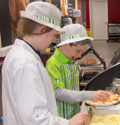 Aaron making pizza at Asda Falkirk with colleague