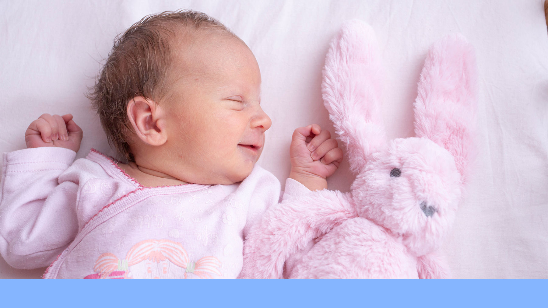 Baby sleeping with a toy rabbit