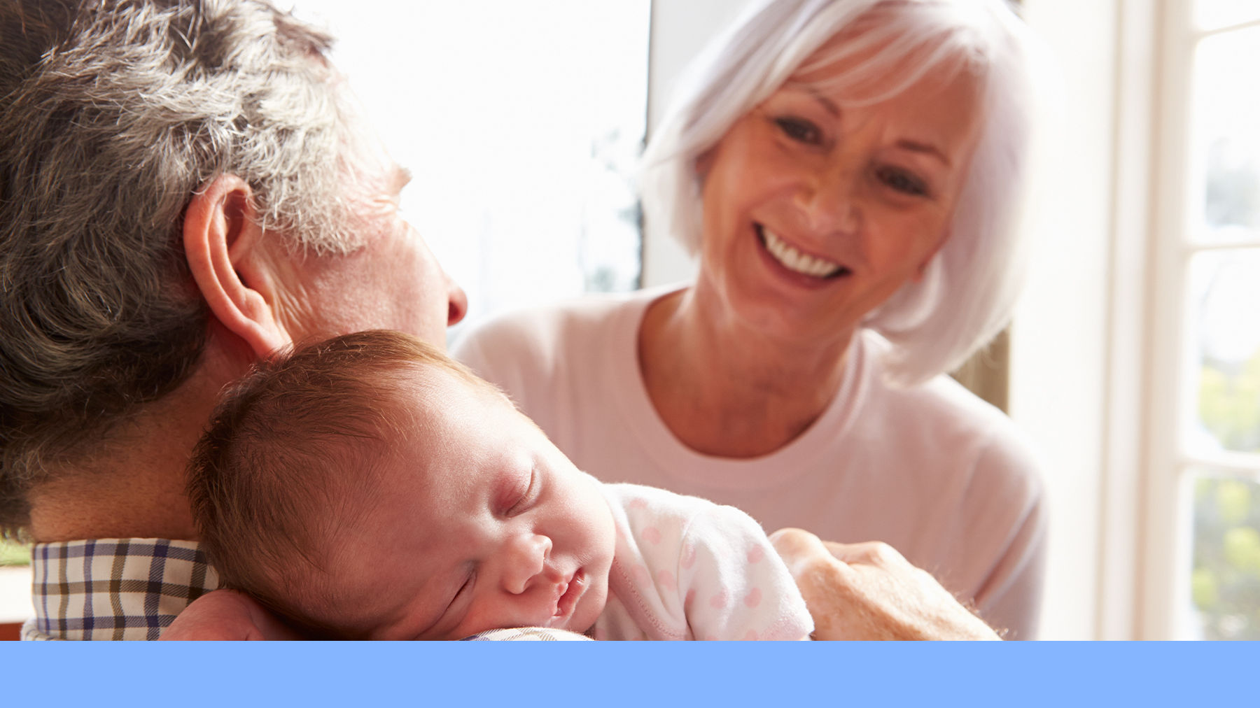 Grandparents holding a newborn baby