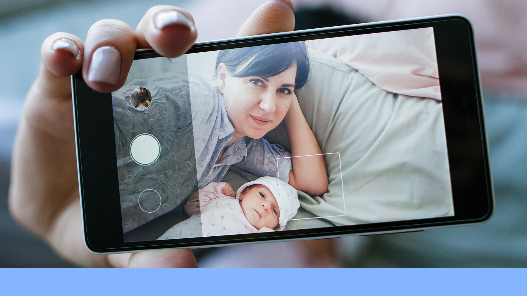Phone taking a picture of mother and baby