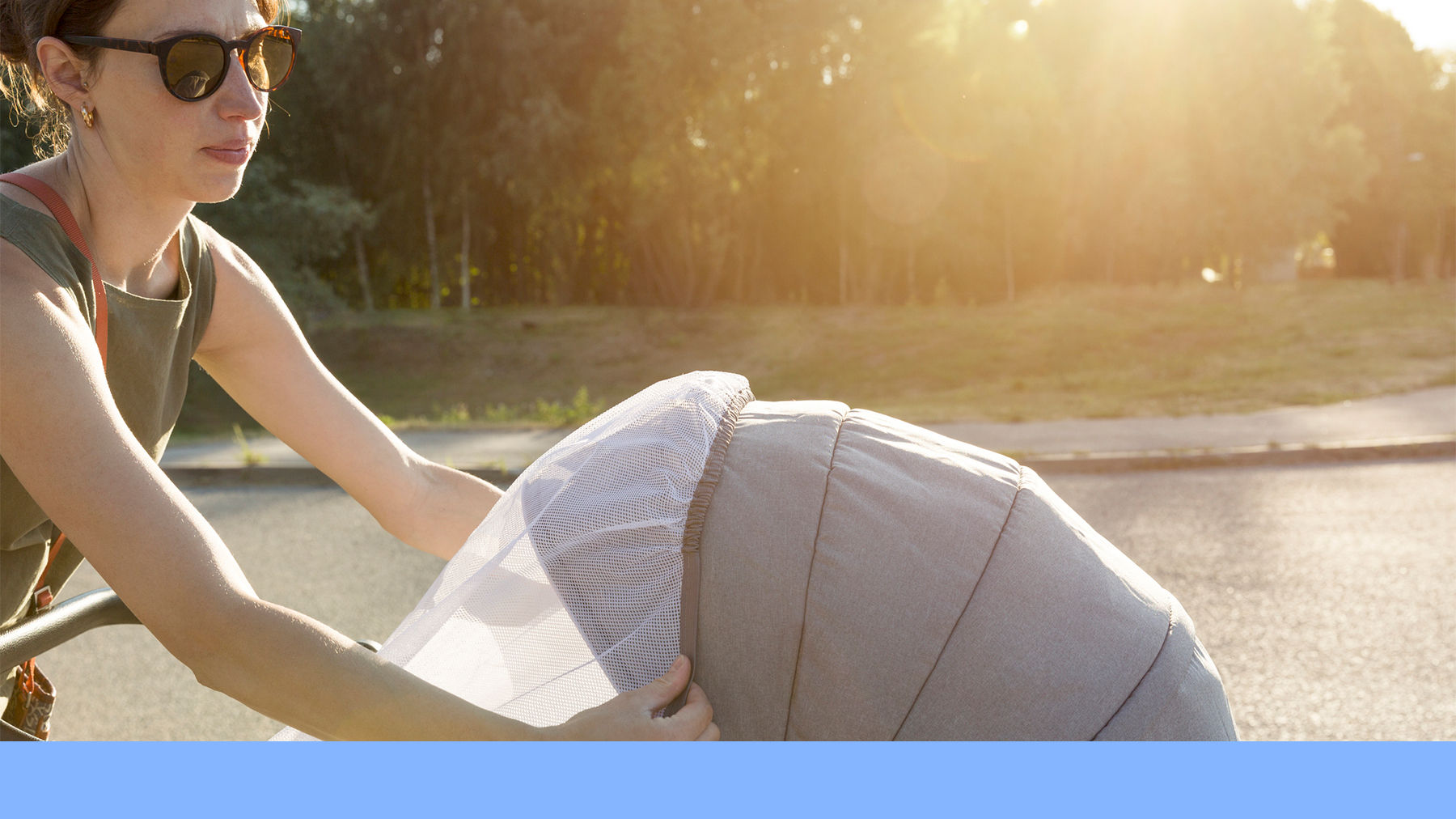 Woman with a pushchair in summer