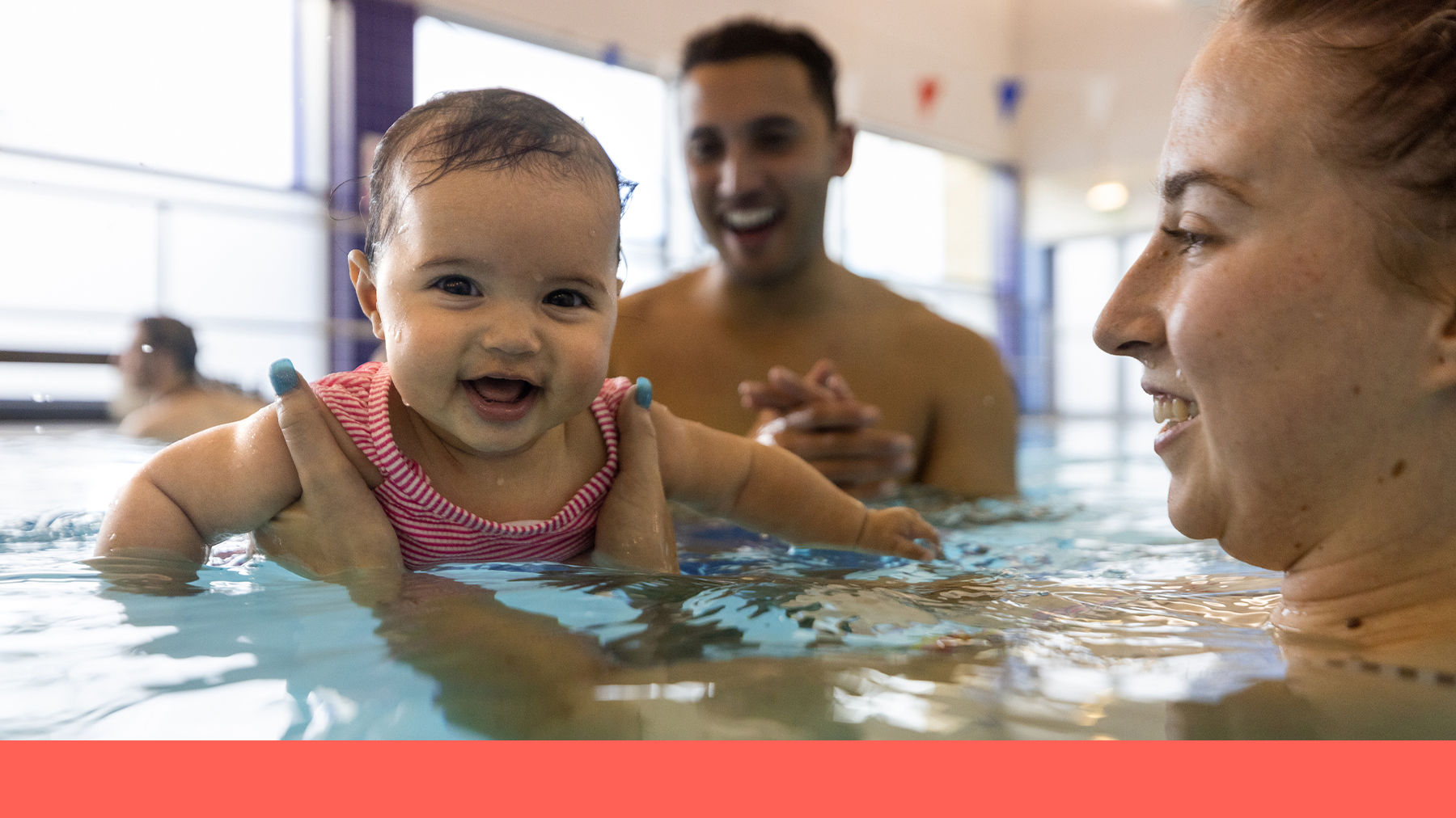 Baby swimming with parents