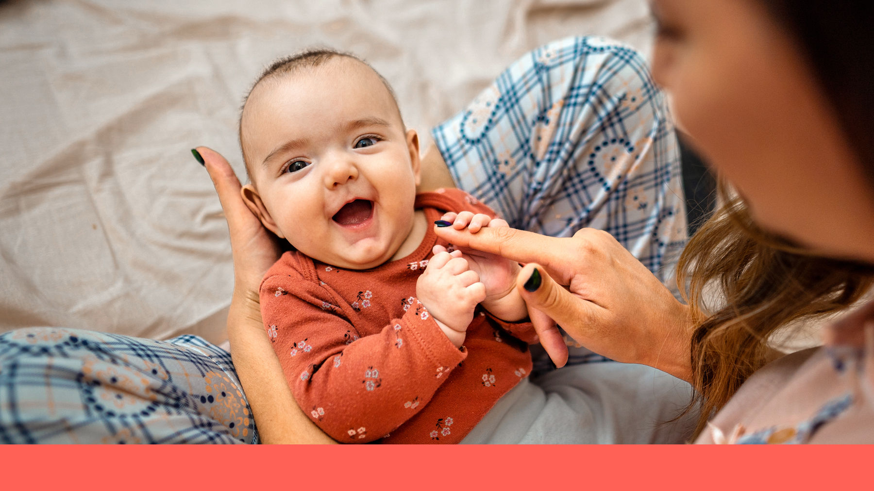 Baby laughing with mother