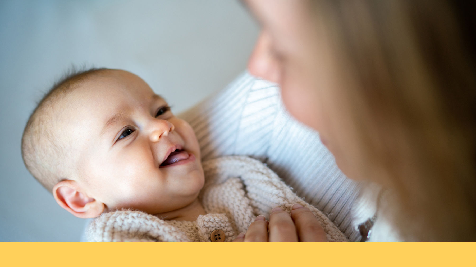 Mother holding smiling baby