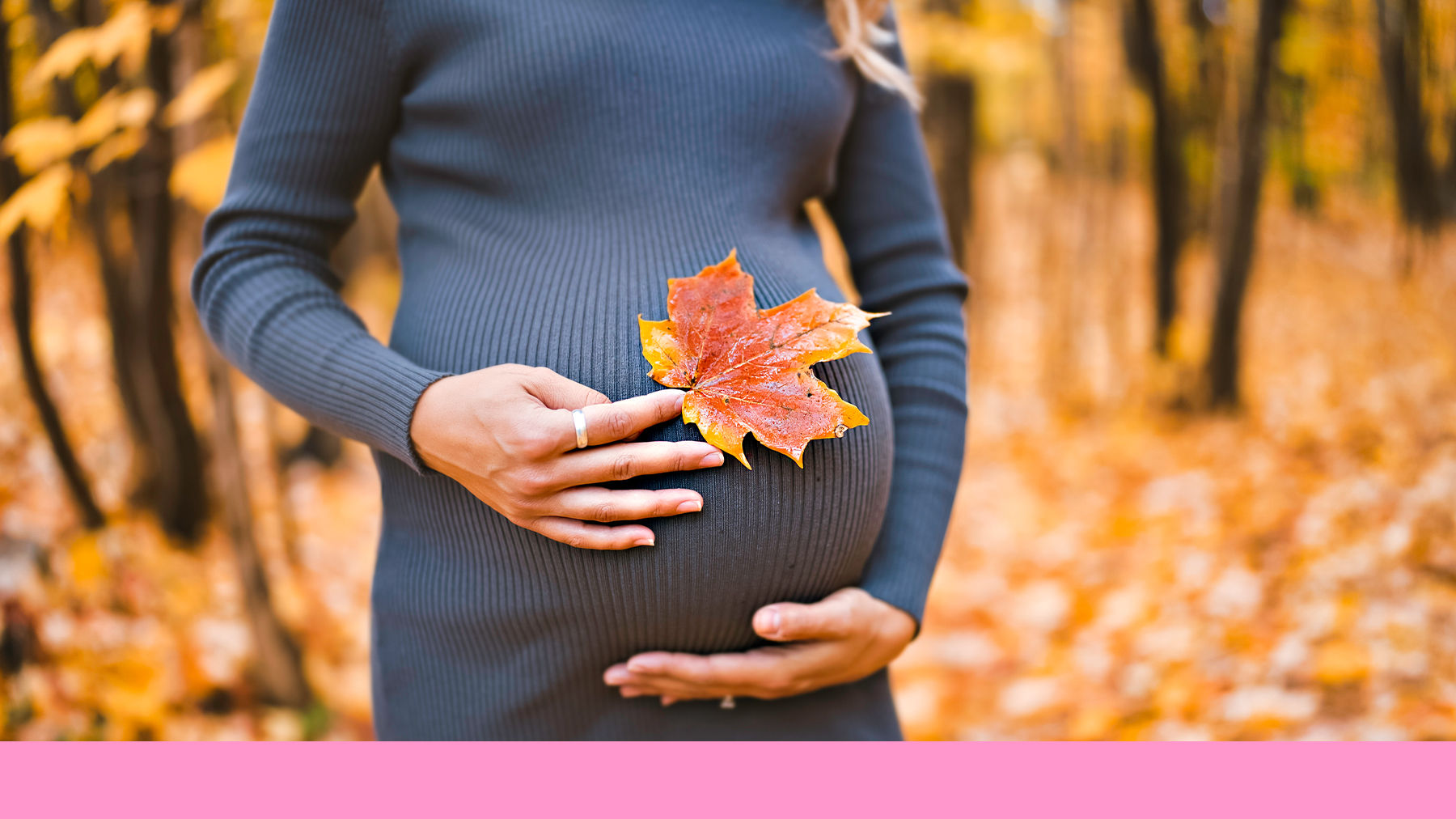 Pregnant woman holding an autumn leaf