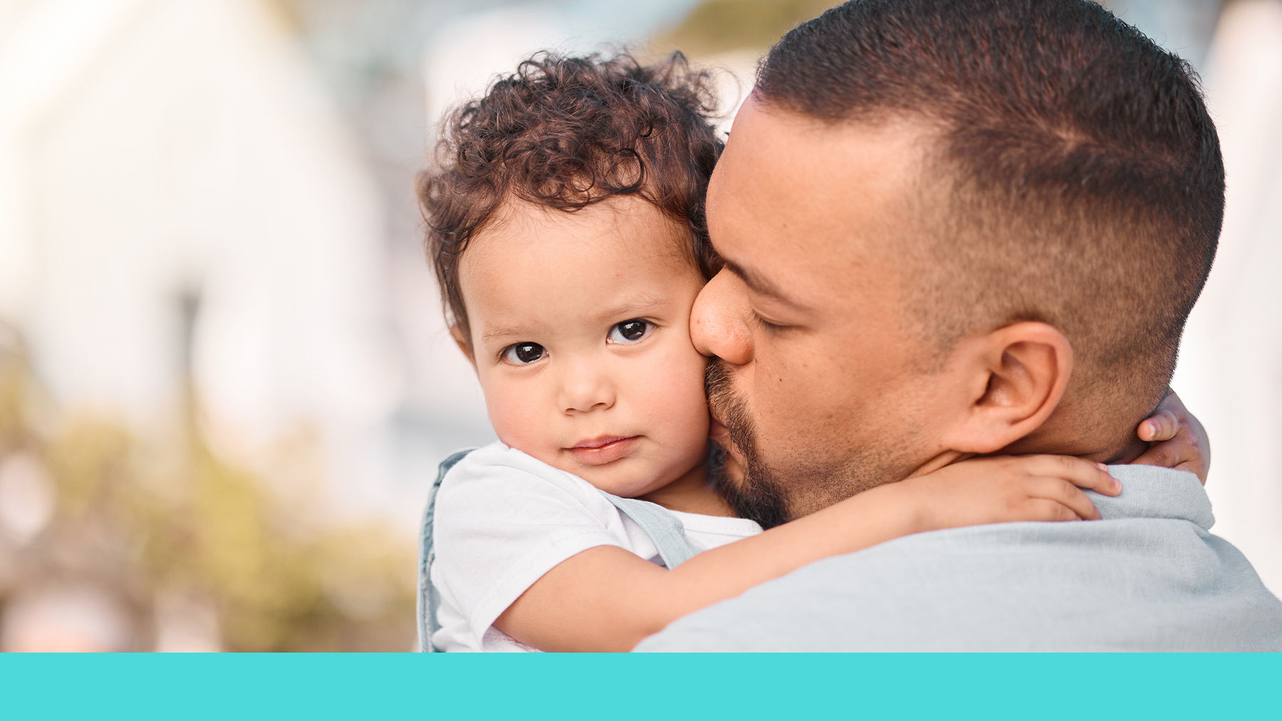 Father kissing toddler