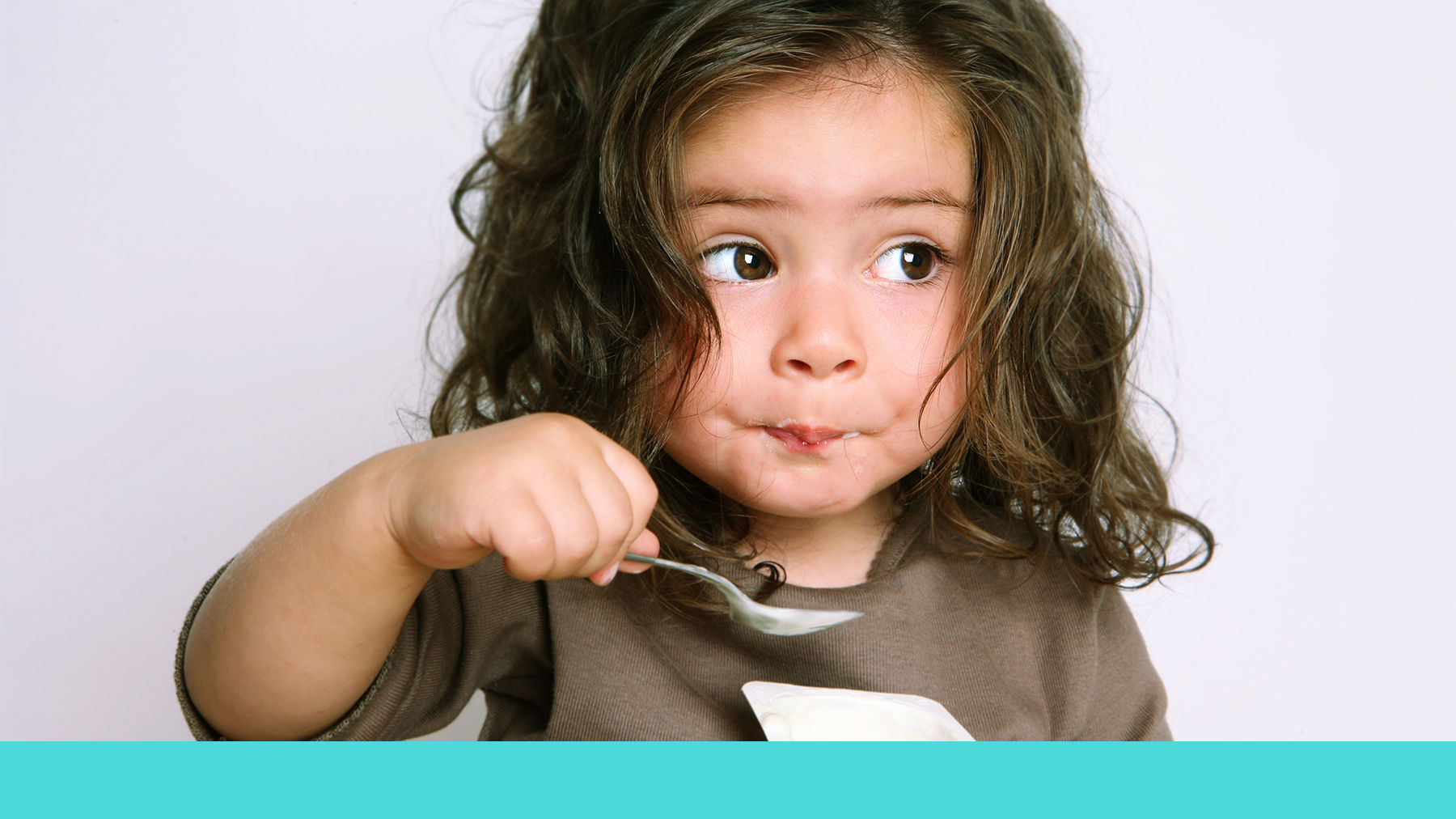 Toddler eating a yoghurt