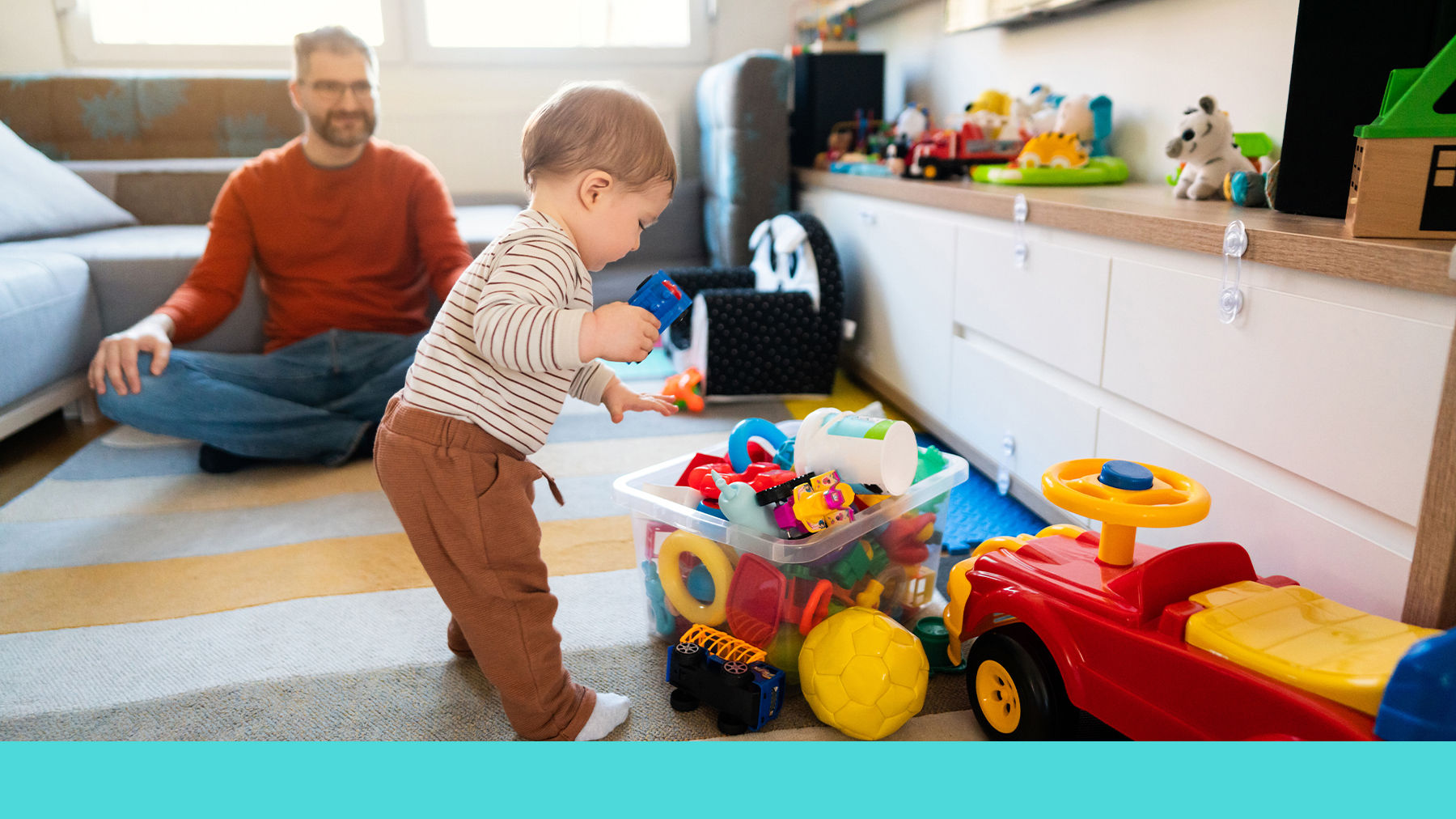 Toddler tidying up their toys