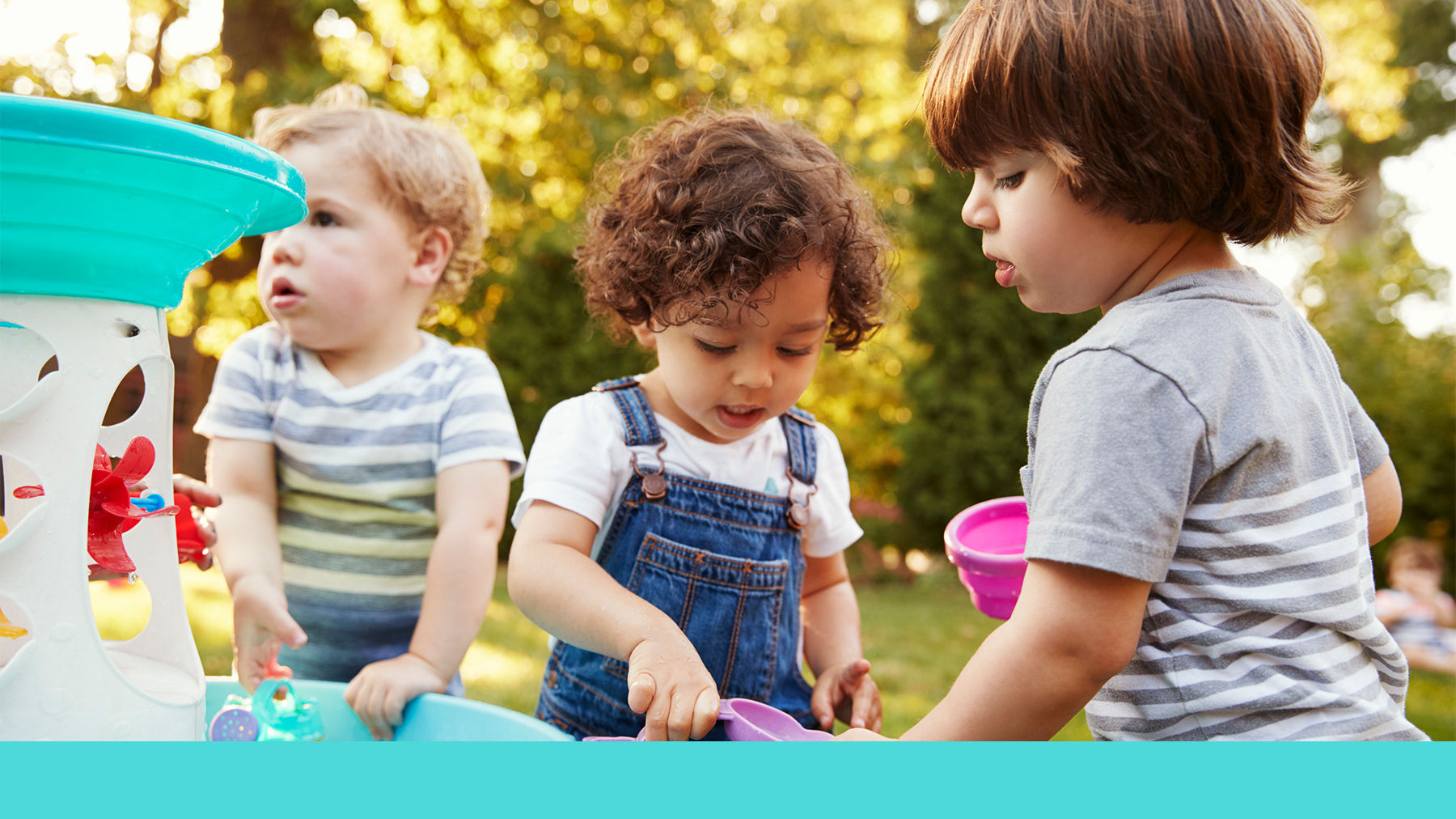 Toddlers playing in toy water fountain