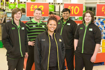 male colleague is standing in front of a wall that says "Click & Collect collection point"