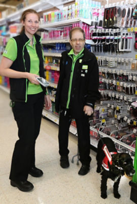 Asda Biggleswade colleagues Helen Jackson and Russell Bryant with Russell's hearing dog Ben