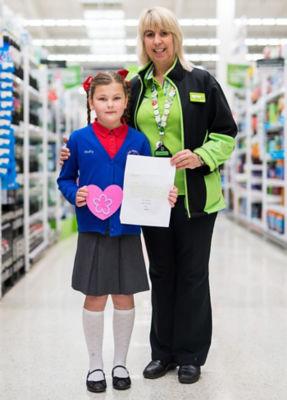 Ruby Edmunds from Aberdare Town Church Primary School and plastic investigators at Asda Aberdare