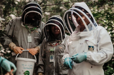 Asda Newport colleagues Kenny Farrell and Clare Jones with the beekeepers