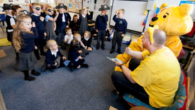 Phil Henderson from Asda reading from Playtime with Pudsey