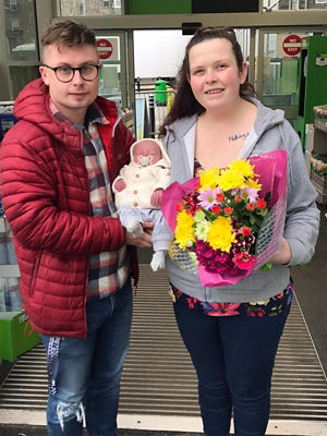 Dean Stawman and Delyth Jones with baby Harry who was born in the Asda Pwllheli car park