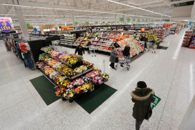 Customers their carts around fresh produce and flowers