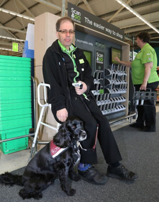 Asda Biggleswade colleague Russell with his hearing dog Ben