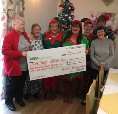 Jo Thexton from Asda Bridgwater presents a Christmas grant to Oak Trees Care Home
