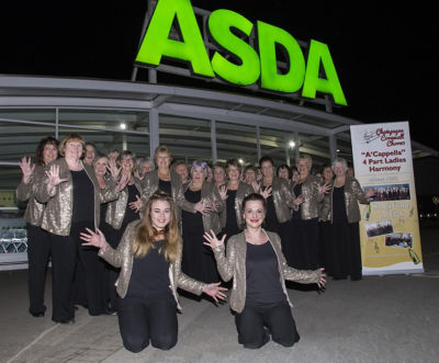 The Champagne Ladies choir group outside of the Adsa store in Bodmin