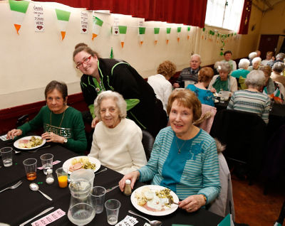 Caroline from Asda Charlton serving guests at the St Patrick's Day party