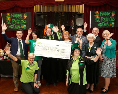Caroline Pettican from Asda Charlton donates a cheque to Irish Community Services