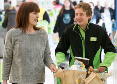 Asda Chatham colleague Joe helping customer Elaine Johnson