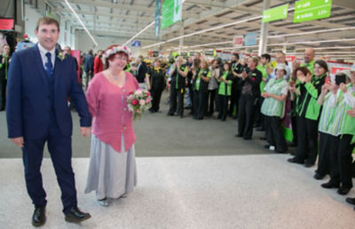 Colleagues at Asda Rawtenstall applaud the newlyweds into the store