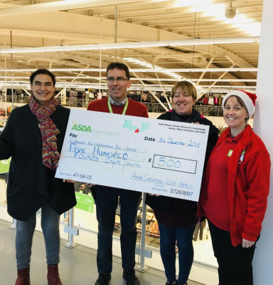 Lisa Kirkpatrick presents a Christmas grant from Asda Falmouth to Cornwall Neighbourhood for Change 