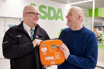 Asda customer Mark Isaac and security colleague Kim Peterson with the life-saving defibrillator