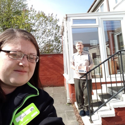 Claire Mackie from Asda Linwood delivers the cake to Ken McGinley