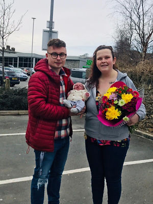 Dean Stawman and Delyth Jones with baby Harry who was born in the Asda Pwllheli car park