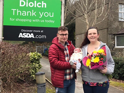 Dean Stawman and Delyth Jones with baby Harry who was born in the Asda Pwllheli car park