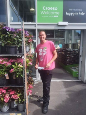 Retained firefighter Neil Shilvock from Asda Pwllheli supports Tickled Pink breast cancer charity campaign