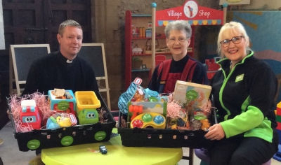 Father Huw Bryant and Daphne Chalk with Asda Pwllheli community champion Jo Scott