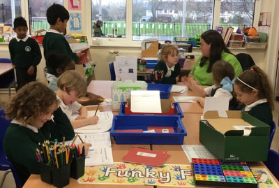 Asda Romford community champion Liz Brown helping pupils at Mead Primary School