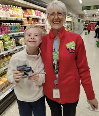 Anne Gaffney from Asda Rossington surprised Logan Roberts with a Christmas gift