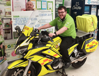 Asda Huyton's community champion Richard presents Merseyside & Cheshire Blood Bikes with an Asda Foundation cheque for £1,000 