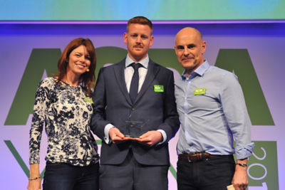 Aston Olver receives his Service Colleague of the Year award from Roger Burnley and Hayley Tatum