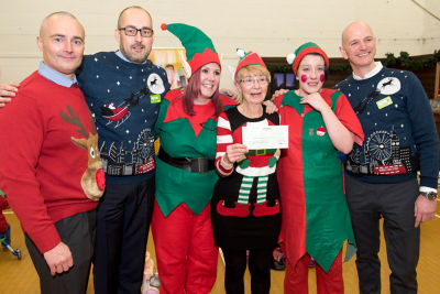 Colleagues and the group with the cheque