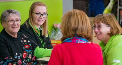 Colleagues Charlotte Earps and Cathy Robinson chat to guests at Asda Warrington's community friendship group