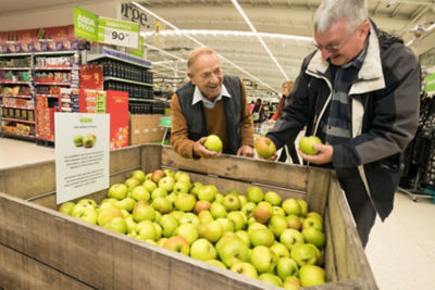 Customers pick up a free Bramley apple from Asda West Bridgford
