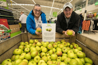 Customers pick up a free apple at Asda West Bridgford